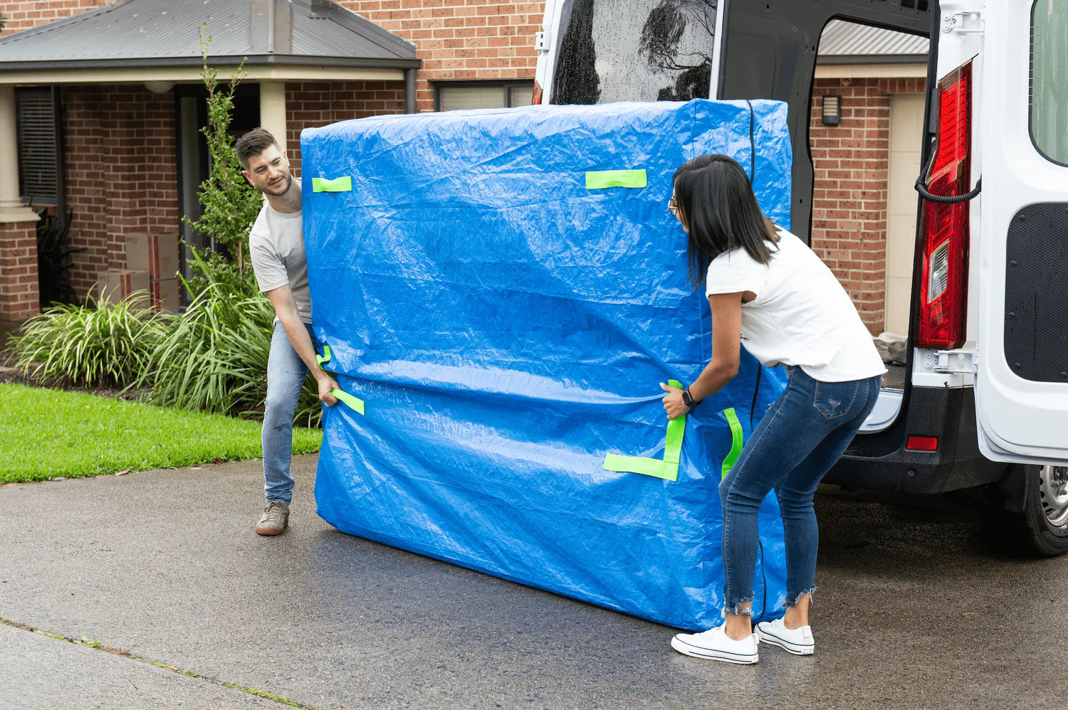 Mattress bags being used to carry a mattress when moving house