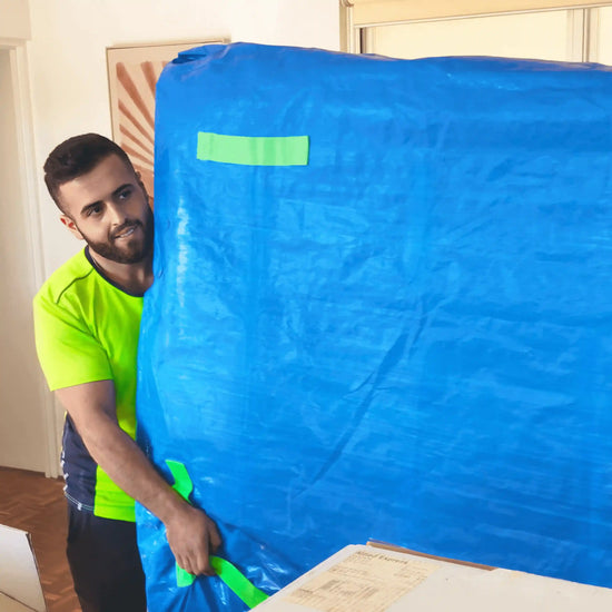 Removalist using a TROVERR mattress bag, helping people move house